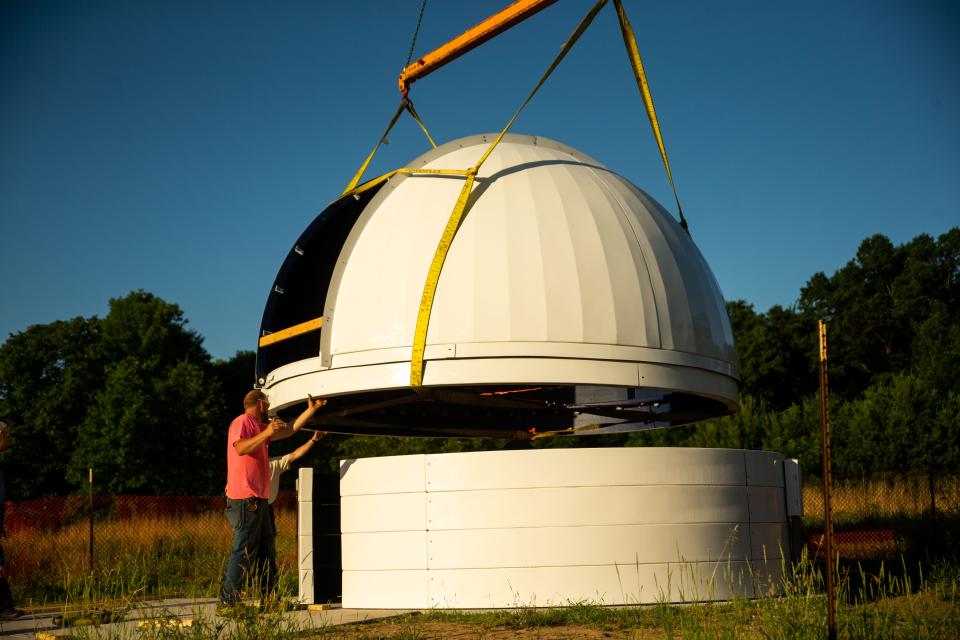 The dome of the new observatory is placed onto its base Friday, June 24, at Hemlock Crossings in West Olive.