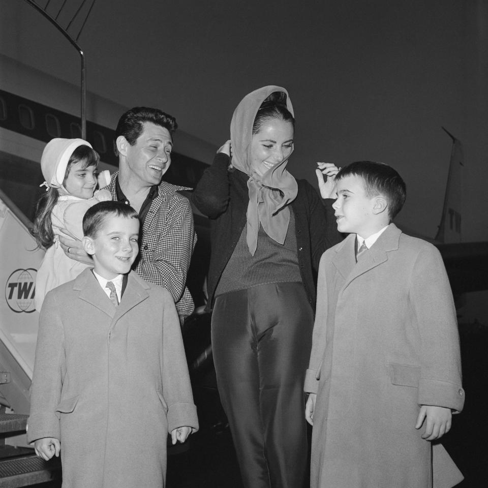 <p>Elizabeth meets her family at the airport after Eddie flew the children over to Rome where the actress was filming <em>Cleopatra</em>.  </p>