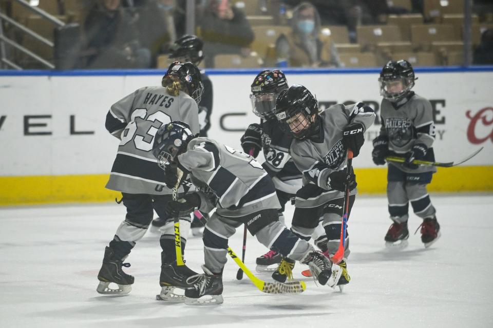 Youth hockey players skate in a scrimmage between periods at Saturday night's Railers game.