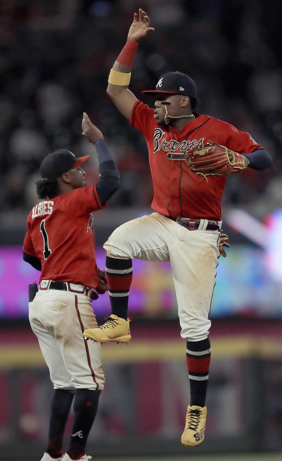 Atlanta Braves' Ronald Acuna Jr., right, celebrates with Ozzie Albies (1) at the end of a baseball game against the St. Louis Cardinals, Friday, June 18, 2021, in Atlanta. (AP Photo/Ben Margot)