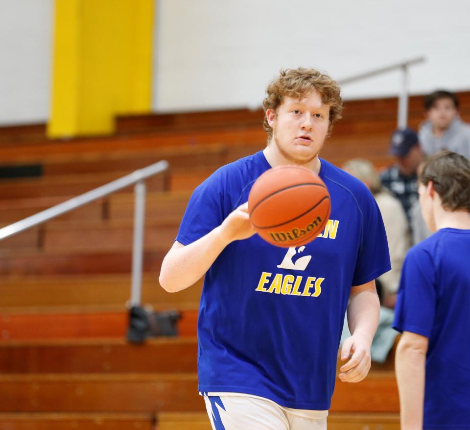Lincoln junior Logan Vance dribbles the ball during warmups before a game against Oldenburg Feb. 12, 2022.