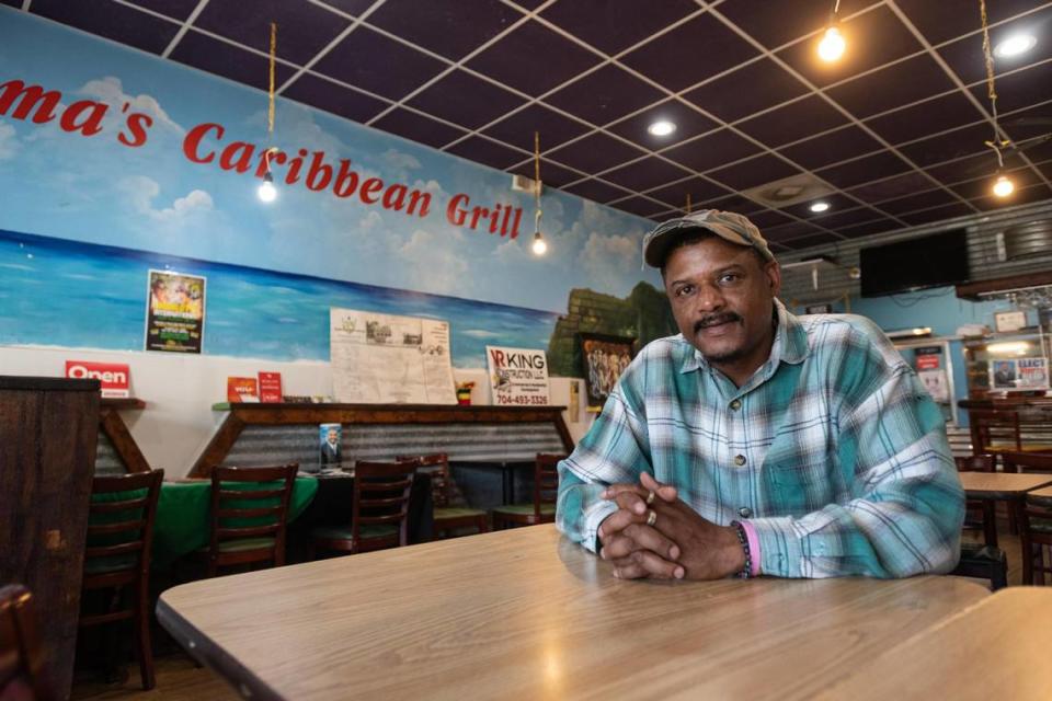 Restaurant owner Vinroy Reid sits for a portrait in the dining room of Mama’s Caribbean Grill at Plaza Midwood in Charlotte, N.C. Wednesday, July 27, 2022.