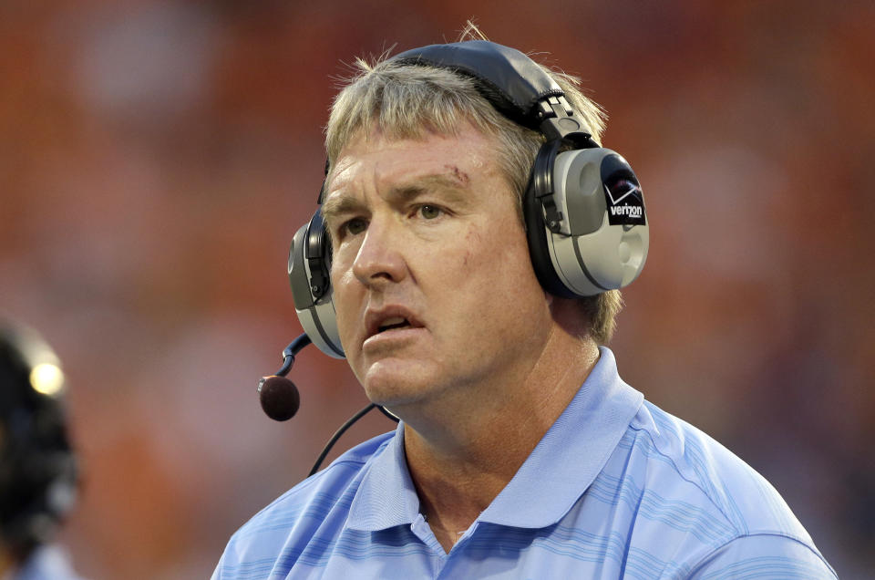 FILE - In this Sept. 27, 2014, file photo, Vic Koenning, at the time the defensive coordinator at North Carolina, watches during the first half of the team's NCAA college football game against Clemson in Clemson, S.C. West Virginia has placed defensive coordinator Koenning on administrative leave after a player alleged the assistant coach made a series of inappropriate comments. West Virginia athletic director Shane Lyons announced the move Tuesday, June 23, 2020, after safety Kerry Martin posted the allegations on his Twitter account. (AP Photo/Bob Leverone, File)