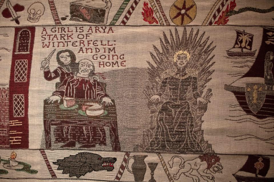 Embroidered scenes on the tapestry depicting the hit television series Game of Thrones are on show at the Ulster Museum in Belfast on July 5, 2019. - Like the Bayeux Tapestry, the Game of Thrones Tapestry is woven of fine linen and hand-embroidered, with decorative borders and a central pictorial narrative. It will reach 90 metres by the end of the final season of the show. (Photo by Paul Faith / AFP)        (Photo credit should read PAUL FAITH/AFP/Getty Images)