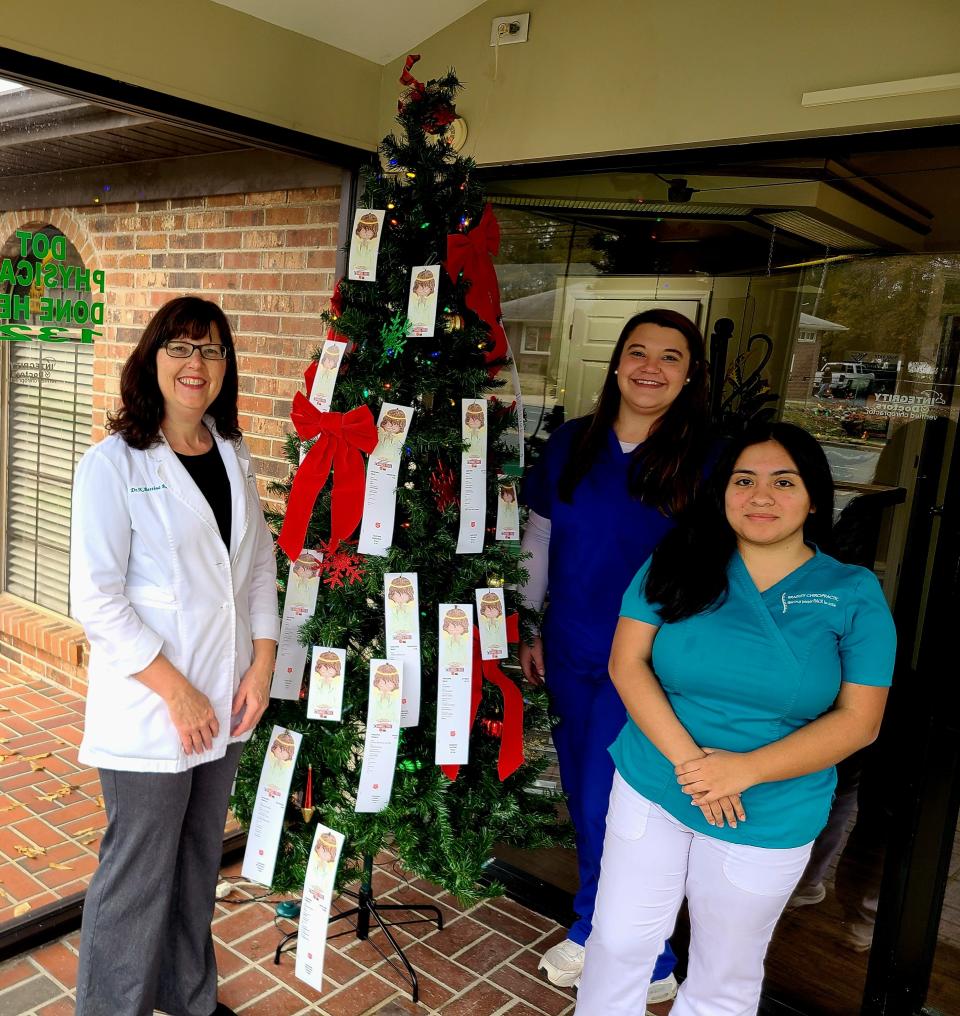 Bettina Royston and staff at Bradley Chiropractic alongside a Salvation Army Angel Tree.