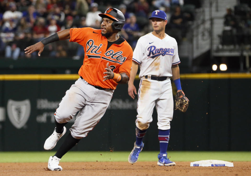 Baltimore Orioles' Maikel Franco rounds second base on a RBI single by Trey Mancini against the Texas Rangers during the eighth inning of a baseball game in Arlington, Texas, Saturday, April 17, 2021. (AP Photo/Ray Carlin)