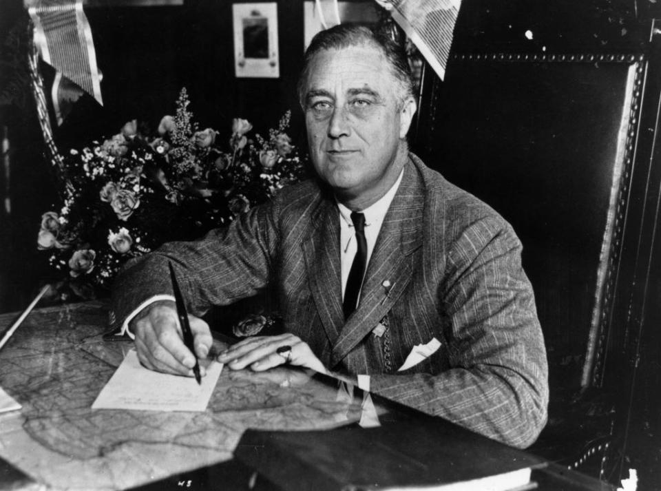 FDR signing something