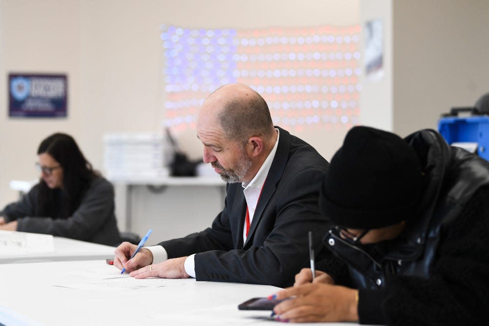 Elections Administrator Chris Davis helps fill out test ballots at the Downtown West early voting and training center on Jan. 31. The Knox County Election Commission was conducting a required voting machine test.
