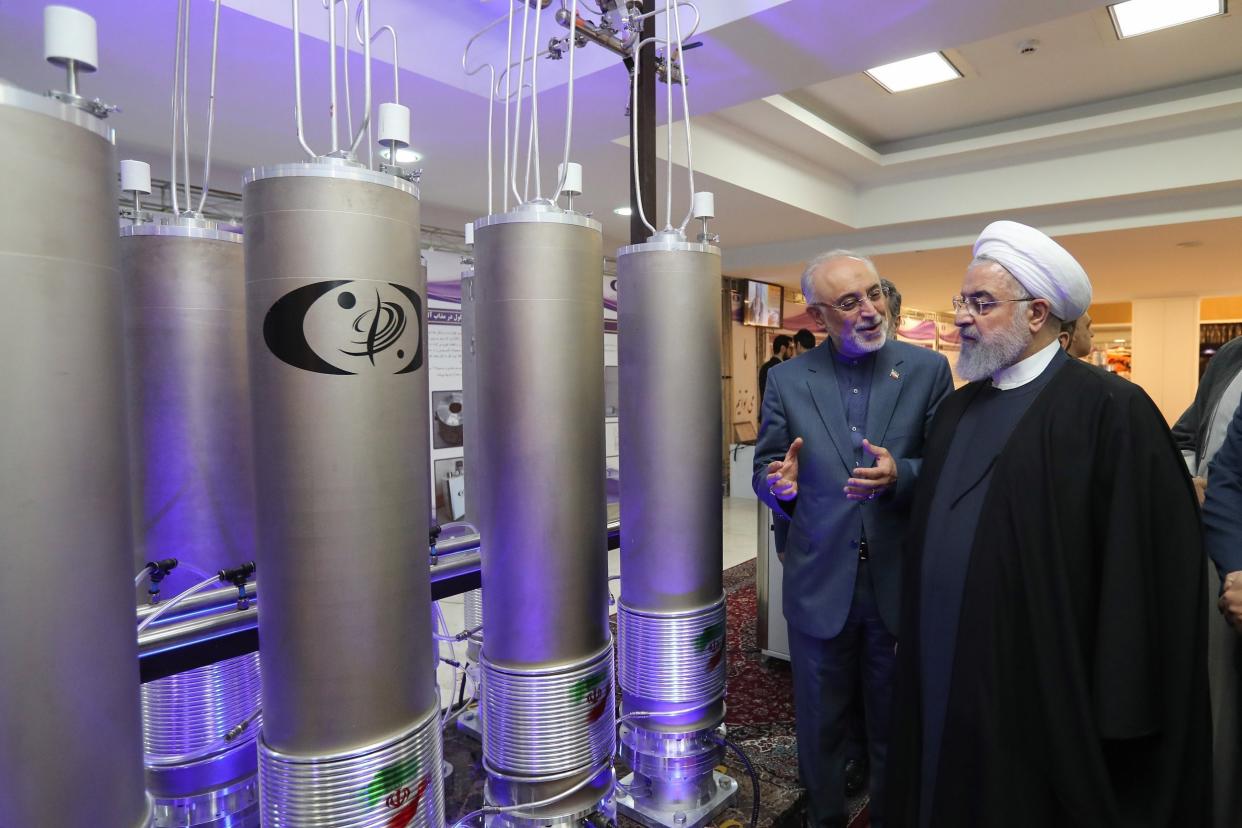 Iranian President Hassan Rouhani (R) and the head of Iran nuclear technology organization Ali Akbar Salehi inspect nuclear technology in Tehran in April 2019: EPA