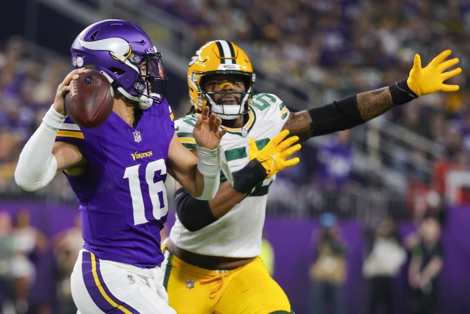 Minnesota Vikings' Jaren Hall looks to pass with Green Bay Packers' Rashan Gary rushing during the first half of an NFL football game Sunday, Dec. 31, 2023, in Minneapolis. (AP Photo/Bruce Kluckhohn)