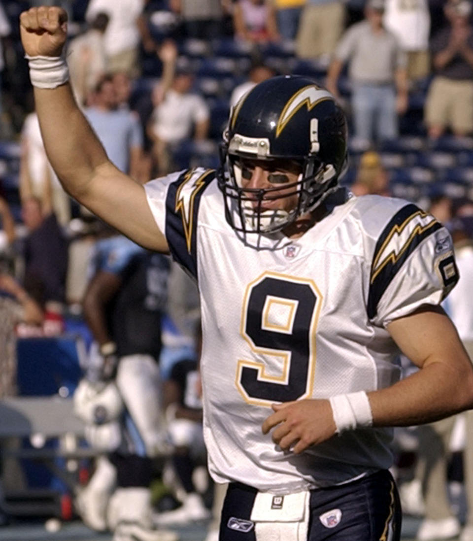File-This Oct. 3, 2004, file photo shows San Diego Chargers quarterback Drew Brees pumping his fist as the Chargers score another touchdown in the fourth quarter of their 38-17 victory over the Tennessee Titans in San Diego. Brees, the NFL’s leader in career completions and yards passing, has decided to retire after 20 NFL seasons, including his last 15 with New Orleans. (AP Photo/Denis Poroy, File)