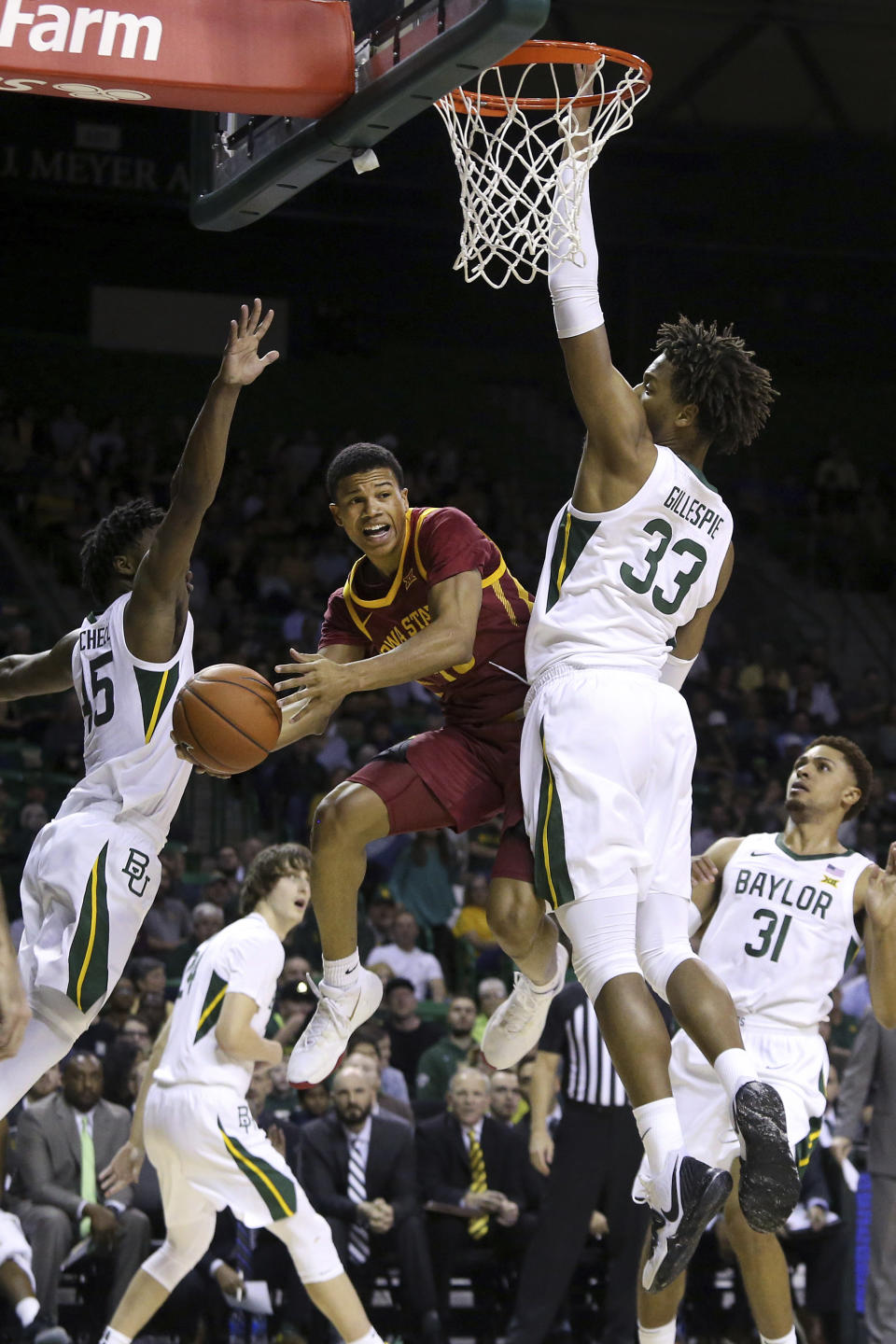 Iowa State guard Rasir Bolton (45) passes the ball between Baylor guard Davion Mitchell (45) and forward Freddie Gillespie (33) during the first half of an NCAA college basketball game Wednesday Jan. 15, 2020, in Waco, Texas. (AP Photo/Jerry Larson)