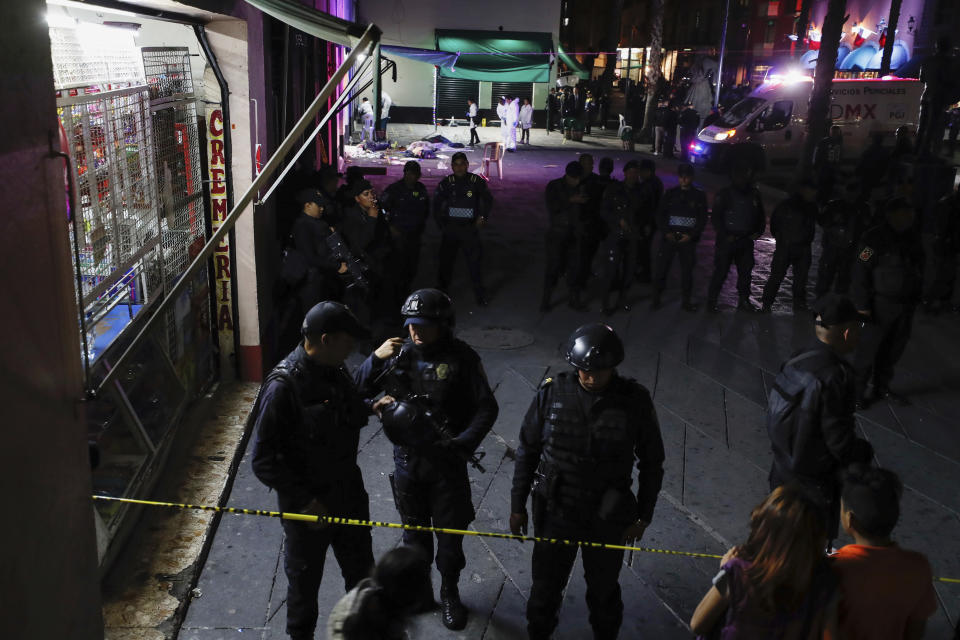 Police block access to a crime scene after a shooting in Plaza Garibaldi in Mexico City, Friday, Sept. 14, 2018. At least four individuals have died in a shooting in Plaza Garibaldi after three gunmen dressed as mariachis opened fired on an establishment that is believed to be a drug distribution point of a local gang. (AP Photo/Stringer)