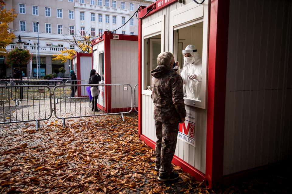 A medic tests a man for the novel coronavirus COVID-19 during nationwide testing in Bratislava, Slovakia on October 31, 2020. - Slovakia on october 31, 2020 began a programme to screen its entire population for coronavirus but medical professionals have warned it could lead to an increase in cases. Some 45,000 medical workers, army and police are being deployed to carry out the tests in the EU member state of 5.4 million people, collecting swabs at around 5,000 testing points. (Photo by VLADIMIR SIMICEK / AFP) (Photo by VLADIMIR SIMICEK/AFP via Getty Images)