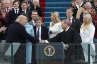 <p>President Donald Trump shakes hands with Supreme Court Chief Justice John Roberts as his family looks on the West Front of the U.S. Capitol on January 20, 2017 in Washington, DC. (Photo: Alex Wong/Getty Images) </p>