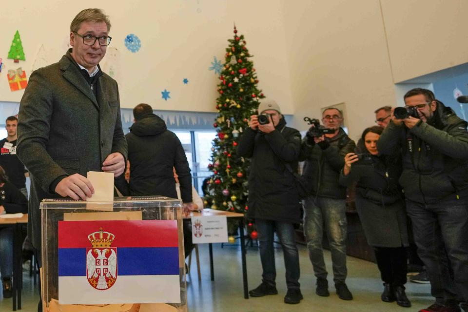 Serbian President Aleksandar Vucic casts his ballot for a parliamentary and local election at a polling station in Belgrade, Serbia, Sunday, Dec. 17, 2023. The vote in Serbia pits Serbian President Aleksandar Vucic's governing Serbian Progressive Party, or SNS, against a pro-Western opposition coalition which is trying to undermine the firm grip on power the populists have maintained since 2012. (AP Photo/Darko Vojinovic)