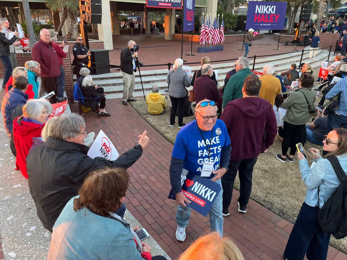 Mark Seckinger, wearing a T-shirt that reads “Make Facts Great Again,” hands out Nikki Haley campaign posters to the crowd during her rally Wednesday in Beaufort.