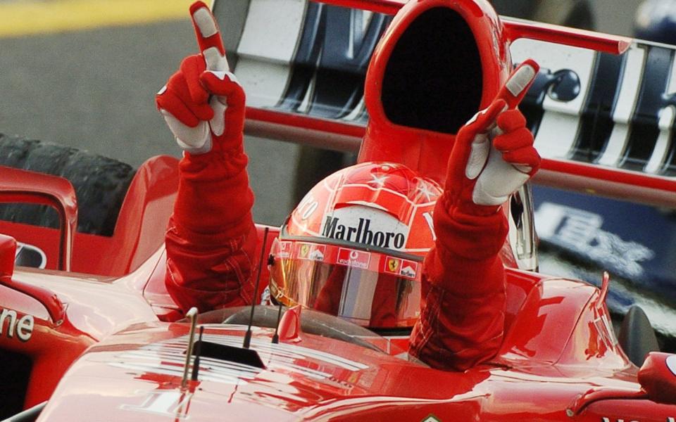 Michael Schumacher of Ferrari wins Japan Grand Prix...epa000292108 German formula one driver Michael Schumacher of Ferrari (R) celebrates his victory in the Japan Grand Prix in Suzuka on Sunday, 10 October 2004. - EPA