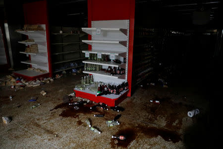 Damage is seen in a supermarket after it was looted during an ongoing blackout in Caracas, Venezuela March 10, 2019. REUTERS/Carlos Garcia Rawlins