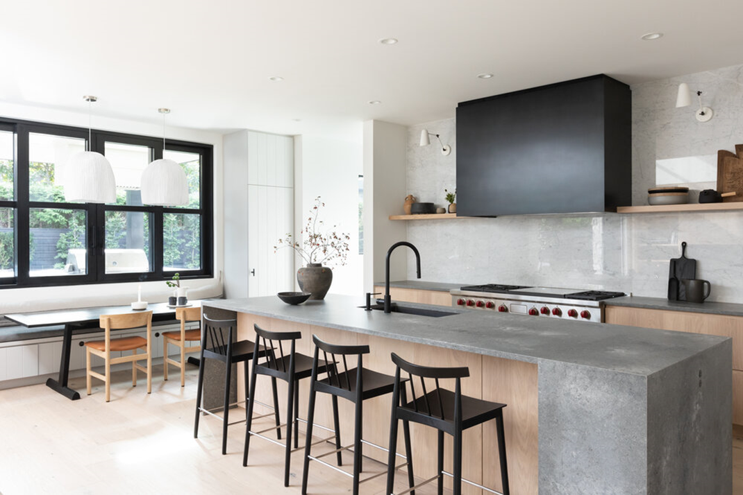  Black sink in white marble kitchen. 