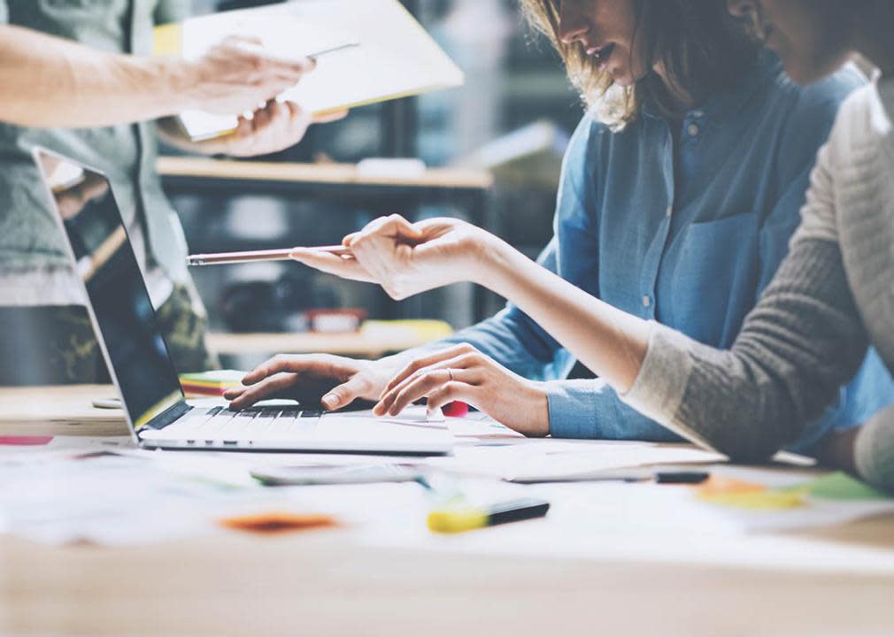 close up of people working, two women looking at computer