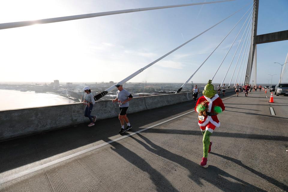 The Grinch and Max make their way over the Talmadge Bridge on Saturday during the annual enmarket Savannah Bridge Run.