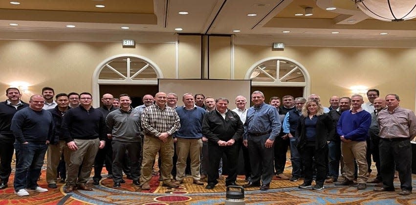 Zoltan Kovacs (center, in black jacket) poses with his co-workers from Wabtec Corp.