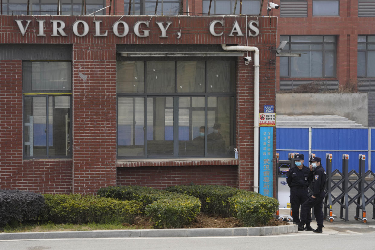 FILE - Security personnel gather near the entrance of the Wuhan Institute of Virology during a visit by the World Health Organization team in Wuhan, China, Feb. 3, 2021. President Joe Biden signed a bipartisan bill on Monday, March 20, 2023, that directs the Office of the Director of National Intelligence to declassify intelligence related to China’s Wuhan Institute of Virology, citing “potential links” between the research that was done there and the outbreak of COVID-19, which the World Health Organization declared a pandemic on March 11, 2020. (AP Photo/Ng Han Guan, File)