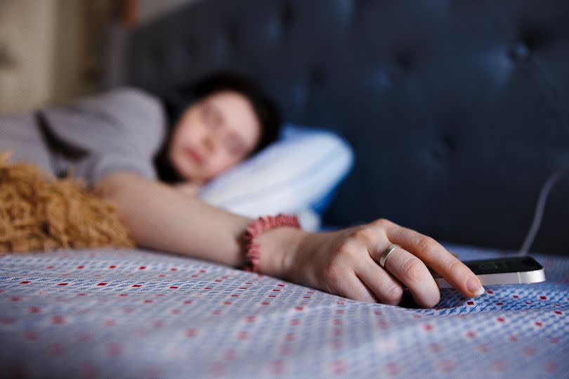 Apple is urgently looking into an iPhone alarm fault after numerous people reported oversleeping -Credit:Getty Images