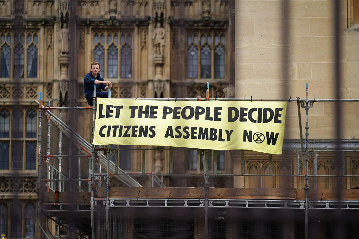 Extinction Rebellion protesters demonstrating on scaffolding, erected for renovation work, outside the Houses of Parliament, Westminster, calling for a Citizen's assembly. The campaign group says supporters have also superglued themselves around the Speaker's chair in the House of Commons chamber. Picture date: Friday September 2, 2022.