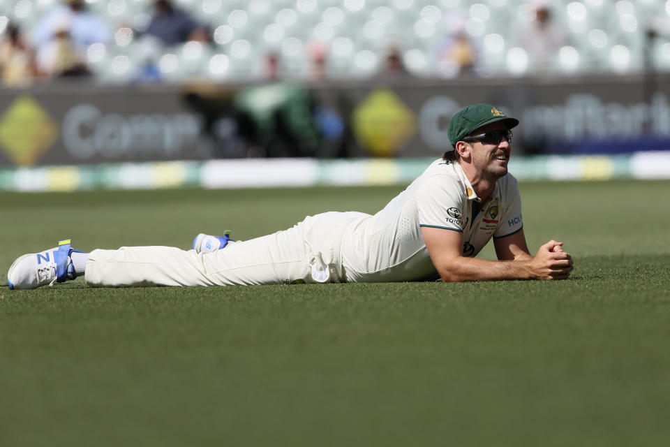 Australia's Mitchell Marsh lays on the ground after missing a catching chance against the West Indies on the second day of their cricket test match in Adelaide, Australia, Thursday, Jan. 18, 2024. (AP Photo/James Elsby)