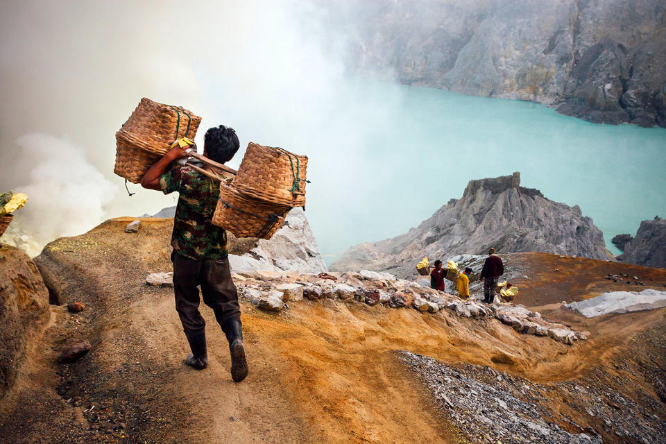 Workmen carry sulfur for a better life