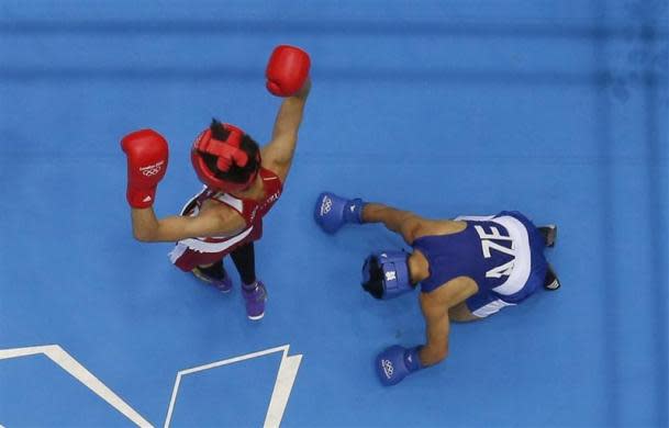 BOXING'S NIGHT OF SHAME: Japan's Satoshi Shimizu (L) reacts as he fights Azerbaijan's Magomed Abdulhamidov (R) who goes to his knees in their Men's Bantam (56kg) Round of 16 boxing match during the London 2012 Olympic Games August 1, 2012.