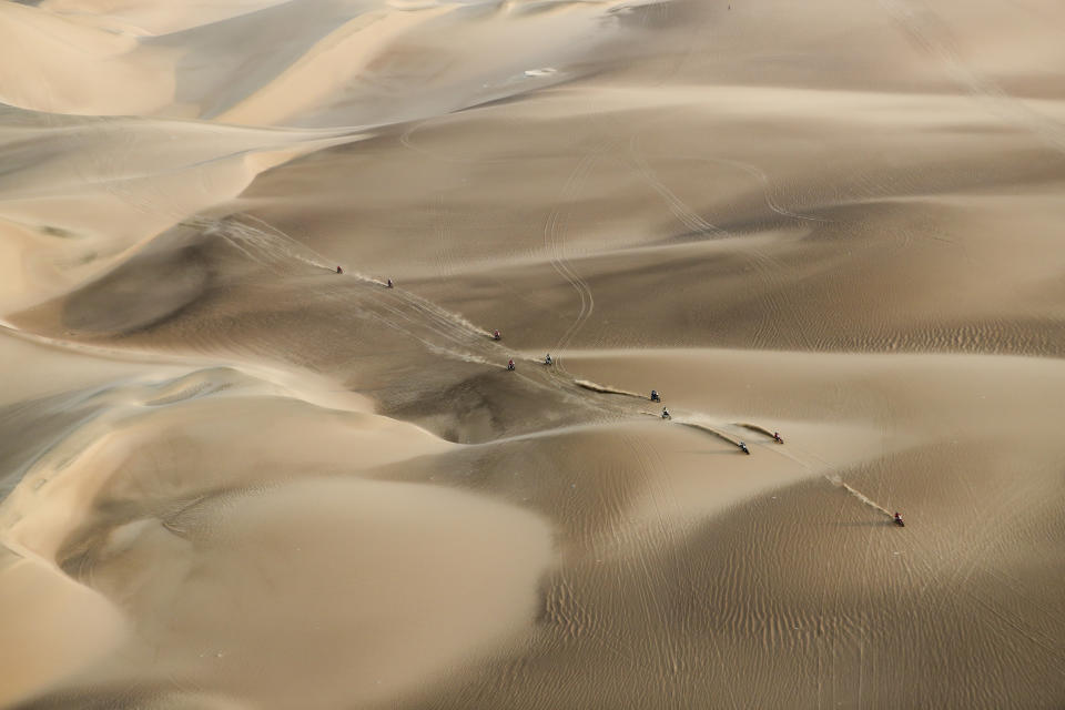 Competitors ride their motorcycles across the dunes during stage nine of the Dakar Rally in Pisco, Peru, on Jan. 16, 2019. (AP Photo/Ricardo Mazalan)