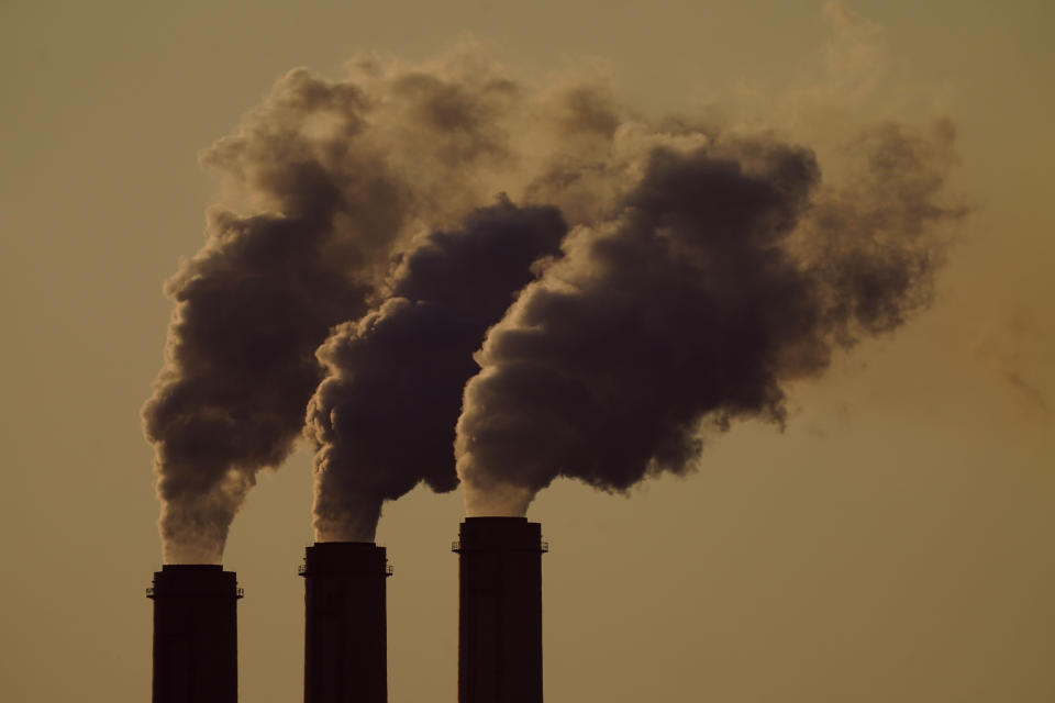 FILE - Emissions rise from the smokestacks at the Jeffrey Energy Center coal power plant as the suns sets, near Emmett, Kan., Sept. 18, 2021. In a victory for President Joe Biden, a federal appeals court Thursday, April 14, 2022 refused to revisit its March decision reviving administration plans to account for potential damage from greenhouse gas emissions when creating rules for polluting industries. (AP Photo/Charlie Riedel, File)