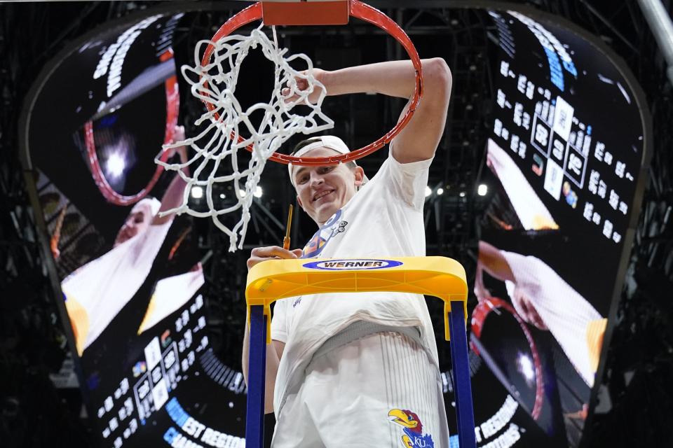 Kansas' Mitch Lightfoot cuts down the net after a college basketball game in the Elite 8 round of the NCAA tournament Sunday, March 27, 2022, in Chicago. Kansas won 76-50 to advance to the Final Four. (AP Photo/Nam Y. Huh)