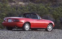 <p>The original Miata, which comes to be known as the NA generation, is officially released as a 1990 model and vaguely resembles a '60s-era Lotus Elan remastered for the 20th century. Its features are endearing, including pop-up headlights that, when opened, give the MX-5 the appearance of a happy, wide-eyed thing-especially in conjunction with the rounded "mouth" in the bumper<br></p>