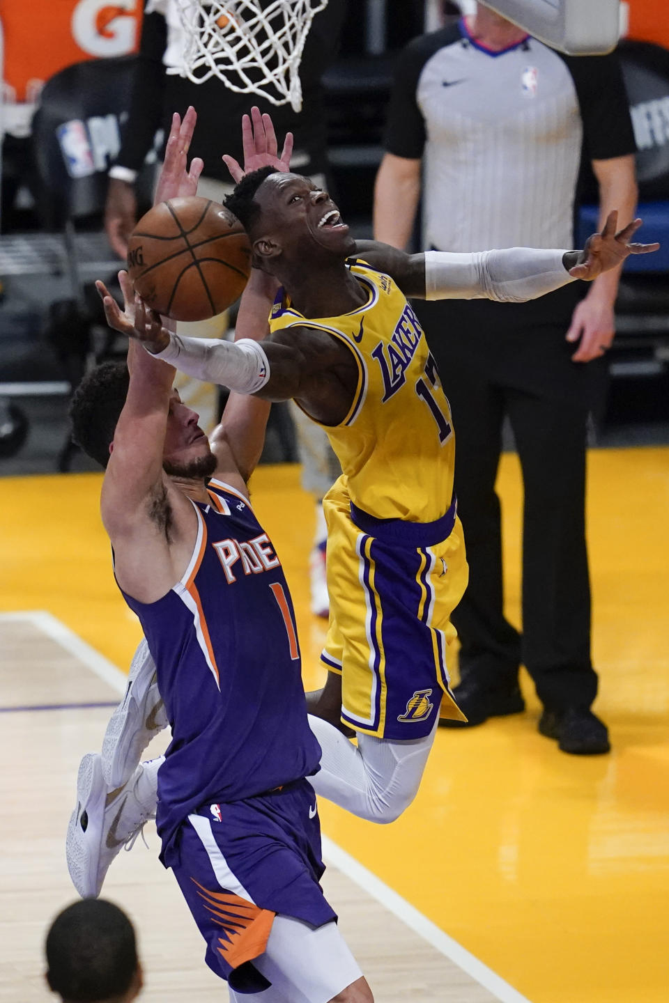 Los Angeles Lakers guard Dennis Schroder (17) shoots against Phoenix Suns guard Devin Booker (1) during the second quarter of Game 6 of an NBA basketball first-round playoff series Thursday, Jun 3, 2021, in Los Angeles. (AP Photo/Ashley Landis)