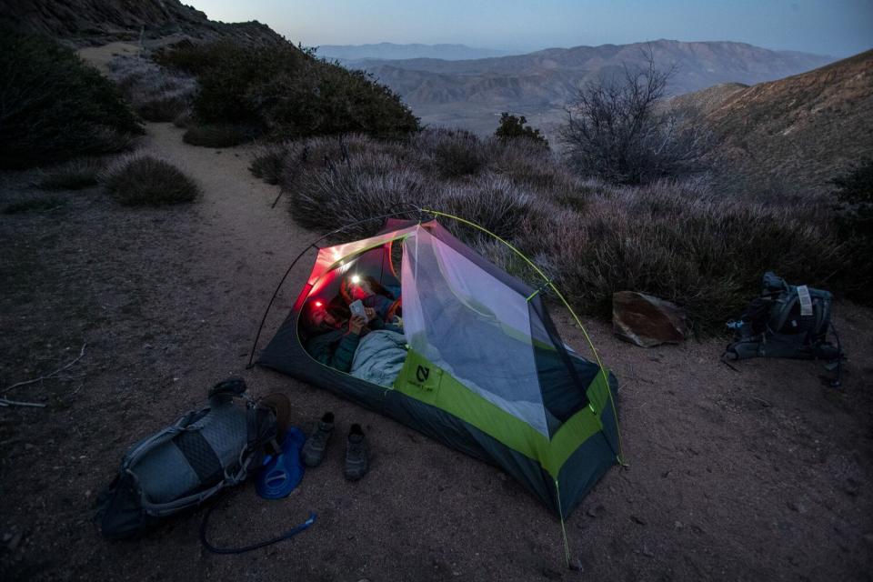 The pair settle in for the night in a tent