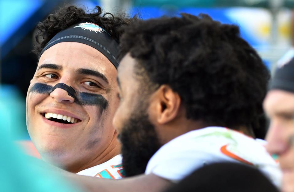 Dolphins outside linebacker Jaelan Phillips smiles on the bench during a game at Hard Rock Stadium this season.