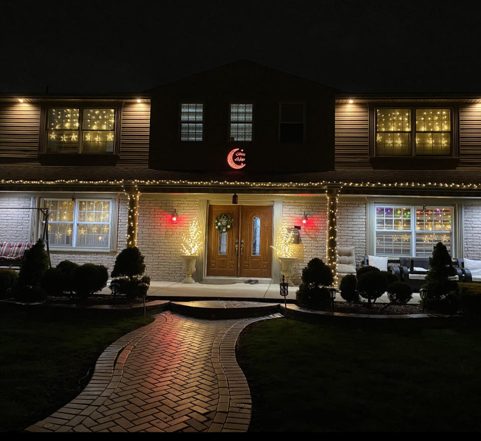 A color-changing crescent moon hangs outside a family's house as part of its Ramadan Lights contest submission. (Photo: Ramadan Lights Contest )