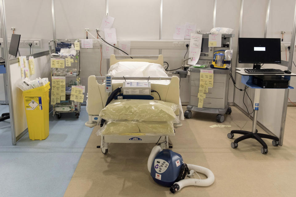 In this photo taken on Tuesday, March 31, 2020, medical equipment is labelled and prepared for use at the ExCel centre which is being made into a temporary hospital, in London. The new hospital - the NHS Nightingale, will comprise of two wards, each of 2,000 people, to help tackle coronavirus. The new coronavirus causes mild or moderate symptoms for most people, but for some, especially older adults and people with existing health problems, it can cause more severe illness or death. (Stefan Rousseau/Pool Photo via AP)