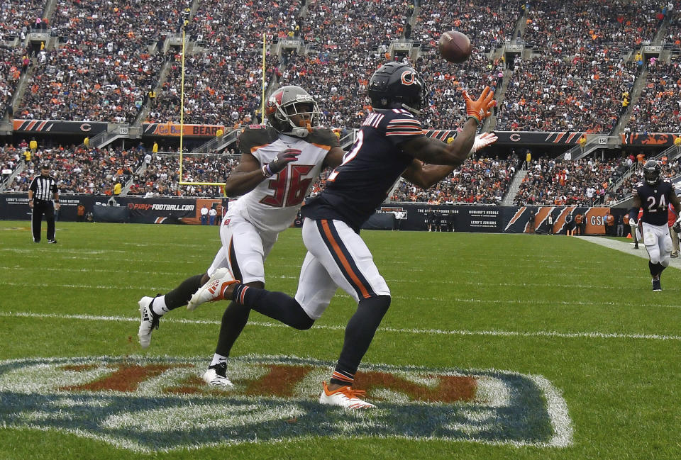 FILE - In this Sept. 30, 2018, file photo, Chicago Bears wide receiver Allen Robinson (12) makes a touchdown reception against Tampa Bay Buccaneers cornerback M.J. Stewart (36) during the first half of an NFL football game in Chicago. A porous defense is threatening to undermine a Buccaneers season that looked so promising after Ryan Fitzpatrick led the team to wins over New Orleans and Super Bowl champion Philadelphia to start the season. Last Sunday's 48-10 loss to the Bears sent the Bucs into their bye week amid questions about whether coach Dirk Koetter might fire defensive coordinator Mike Smith during a break that couldn't arrive soon enough. (AP Photo/David Banks, File)