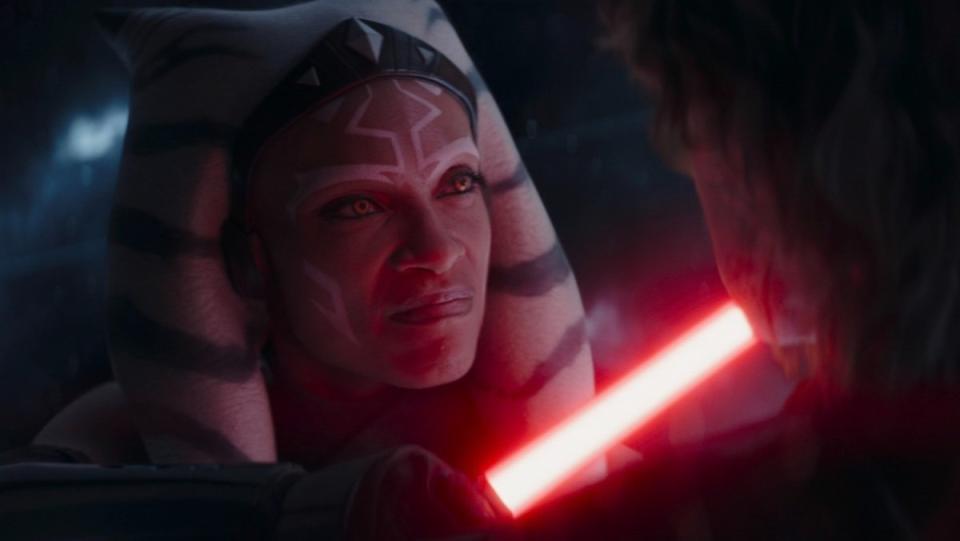 Angry Ahsoka Tano holds a red lightsaber to Anakin's neck