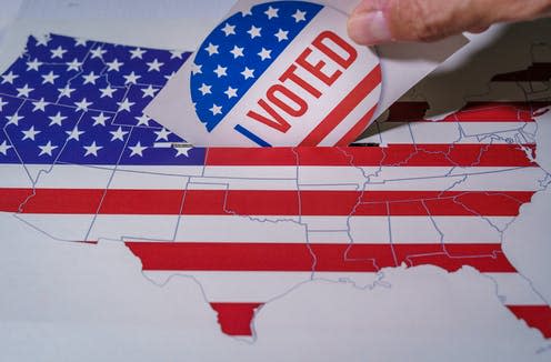 <span class="caption">Around 3 million Americans who live abroad are eligible to vote. </span> <span class="attribution"><a class="link " href="https://www.shutterstock.com/image-photo/usa-elections-2020-hand-man-putting-1796202586" rel="nofollow noopener" target="_blank" data-ylk="slk:Ivan Marc/Shutterstock;elm:context_link;itc:0;sec:content-canvas">Ivan Marc/Shutterstock</a></span>