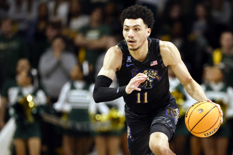 Memphis guard Jahvon Quinerly brings the ball downcourt during the first half of an NCAA college basketball game against UAB, Sunday, Jan. 28, 2024, in Birmingham, Ala. (AP Photo/Butch Dill)