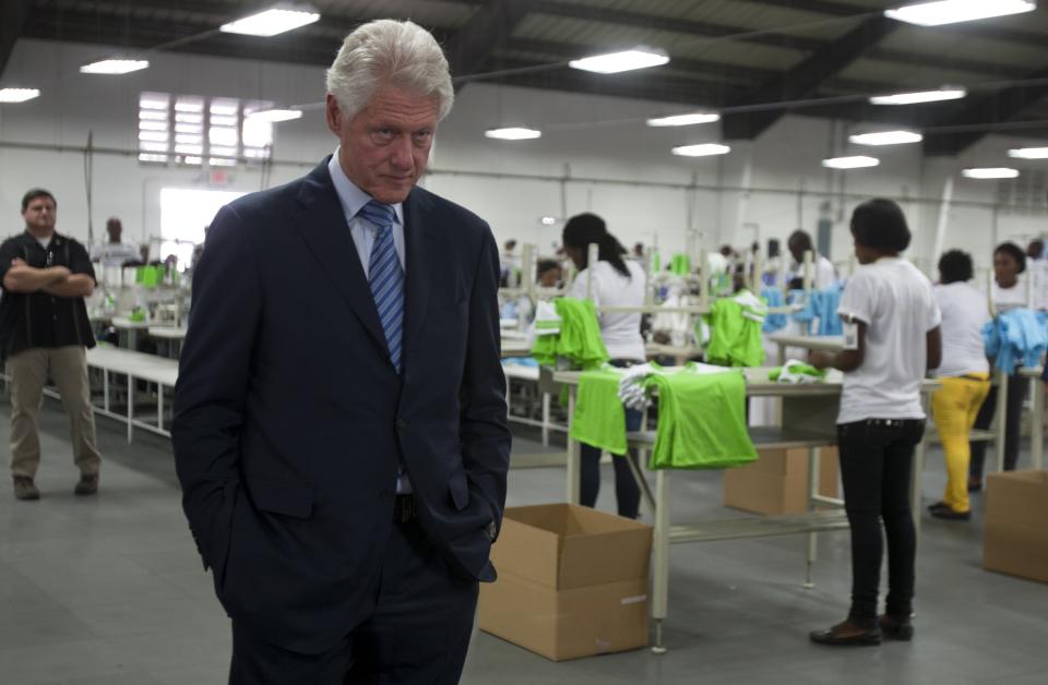 Former U.S. President Bill Clinton walks inside the floor of the new apparel manufacturer Industrial Revolution II, S.A. in Port-au-Prince, Haiti, Tuesday Feb. 18, 2014. Clinton visited the manufacturer, which plans to reinvest half its profits into a health care and education program. The former U.S. president is in a two-day trip to Haiti to visit several projects that focus on agriculture and the environment. (AP Photo/Dieu Nalio Chery)