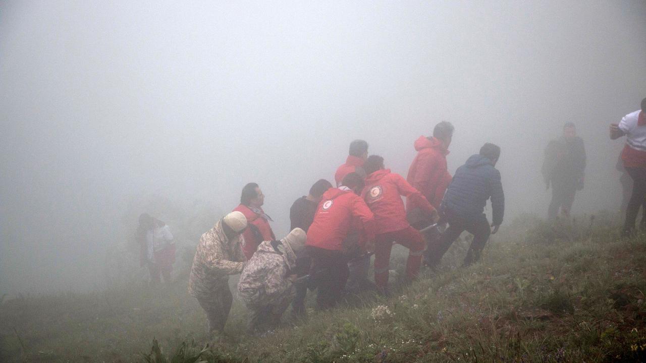 In this photo provided by Moj News Agency, rescue team members carry the body of a victim after a helicopter carrying Iranian President Ebrahim Raisi crashed in Varzaghan in northwestern Iran, Monday, May 20, 2024. Raisi, the country’s foreign minister and several other officials were found dead on Monday, hours after their helicopter crashed in a foggy, mountainous region of the country’s northwest, state media reported. (Azin Haghighi, Moj News Agency via AP)