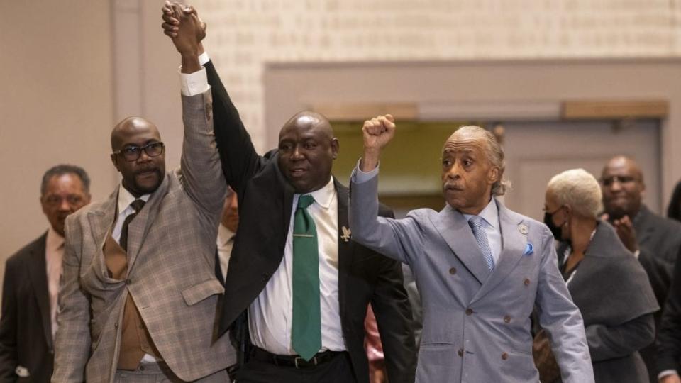 (L-R) Philonise Floyd, Floyd family attorney Ben Crump and the Rev. Al Sharpton raise their fists following today’s verdict in the trial of Derek Chauvin on April 19, 2021 in Minneapolis, Minnesota. (Photo by Nathan Howard/Getty Images)