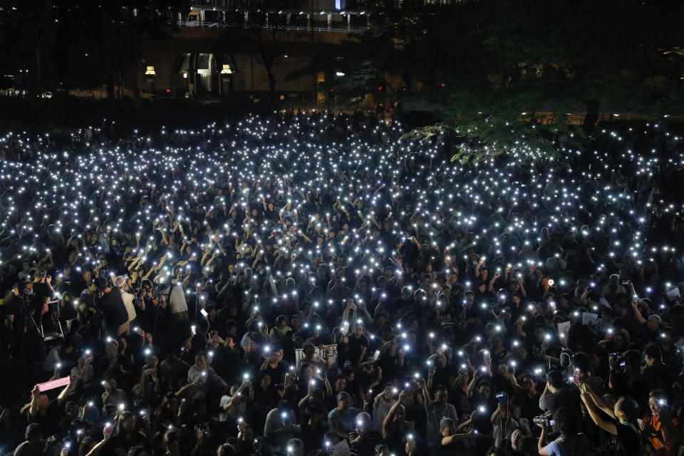 Attendees light up their mobile phones during a rally by mothers in Hong Kong on Friday, July 5, 2019. Student unions from two Hong Kong universities said Friday that they have turned down invitations from city leader Carrie Lam for talks about the recent unrest over her proposal to allow the extradition of suspects to mainland China. (AP Photo/Kin Cheung)